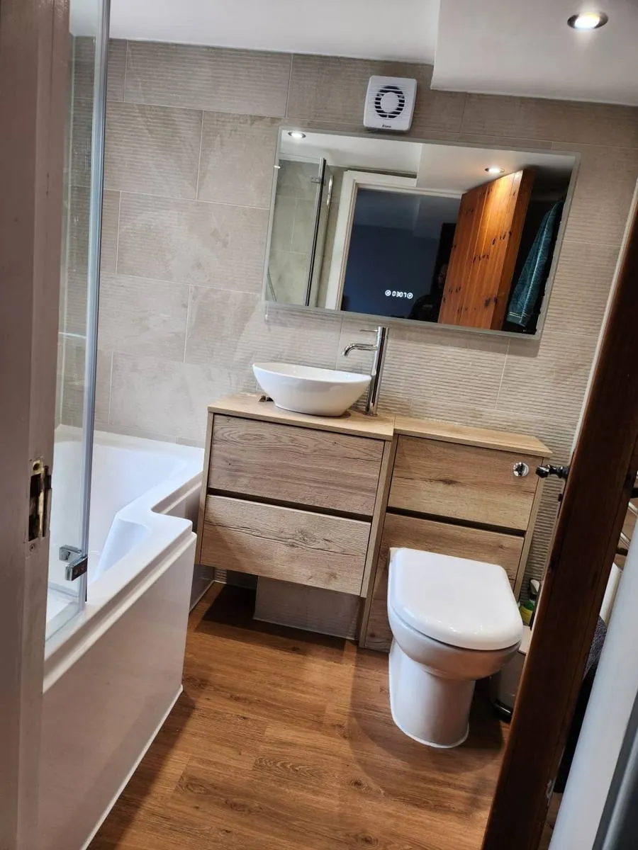 Bathroom renovation with timber vanity, countertop basin and bath