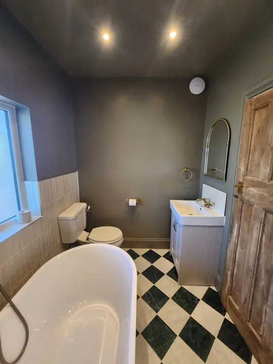 Chequerboard bathroom with brass
