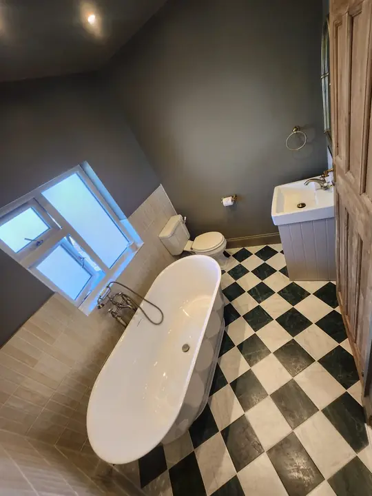 Chequerboard bathroom with brass