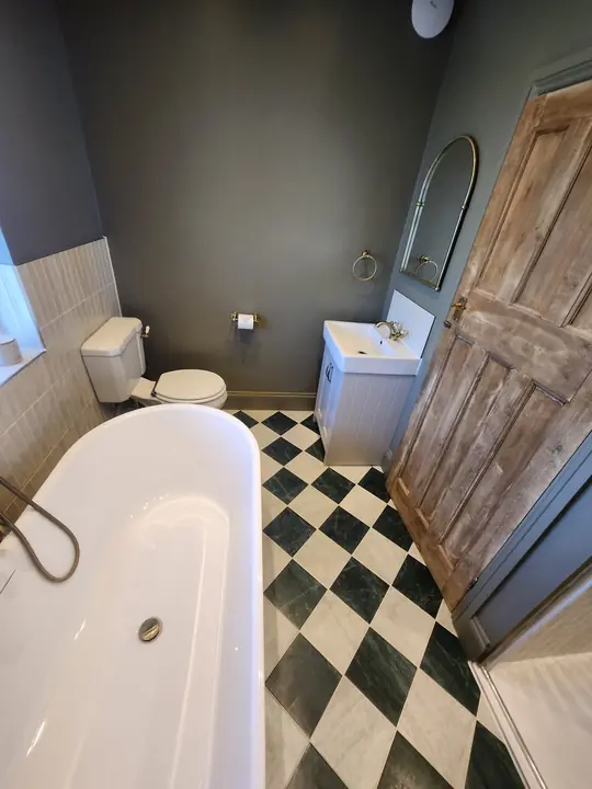 Chequerboard bathroom with brass
