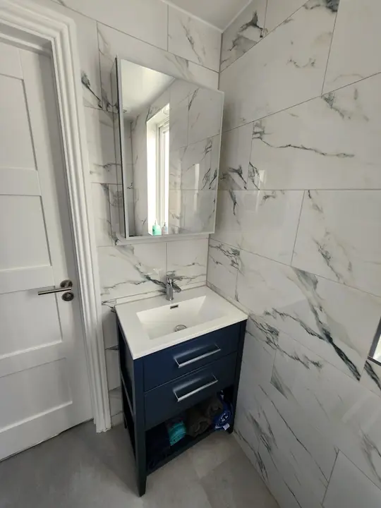 Marble ensuite with navy vanity